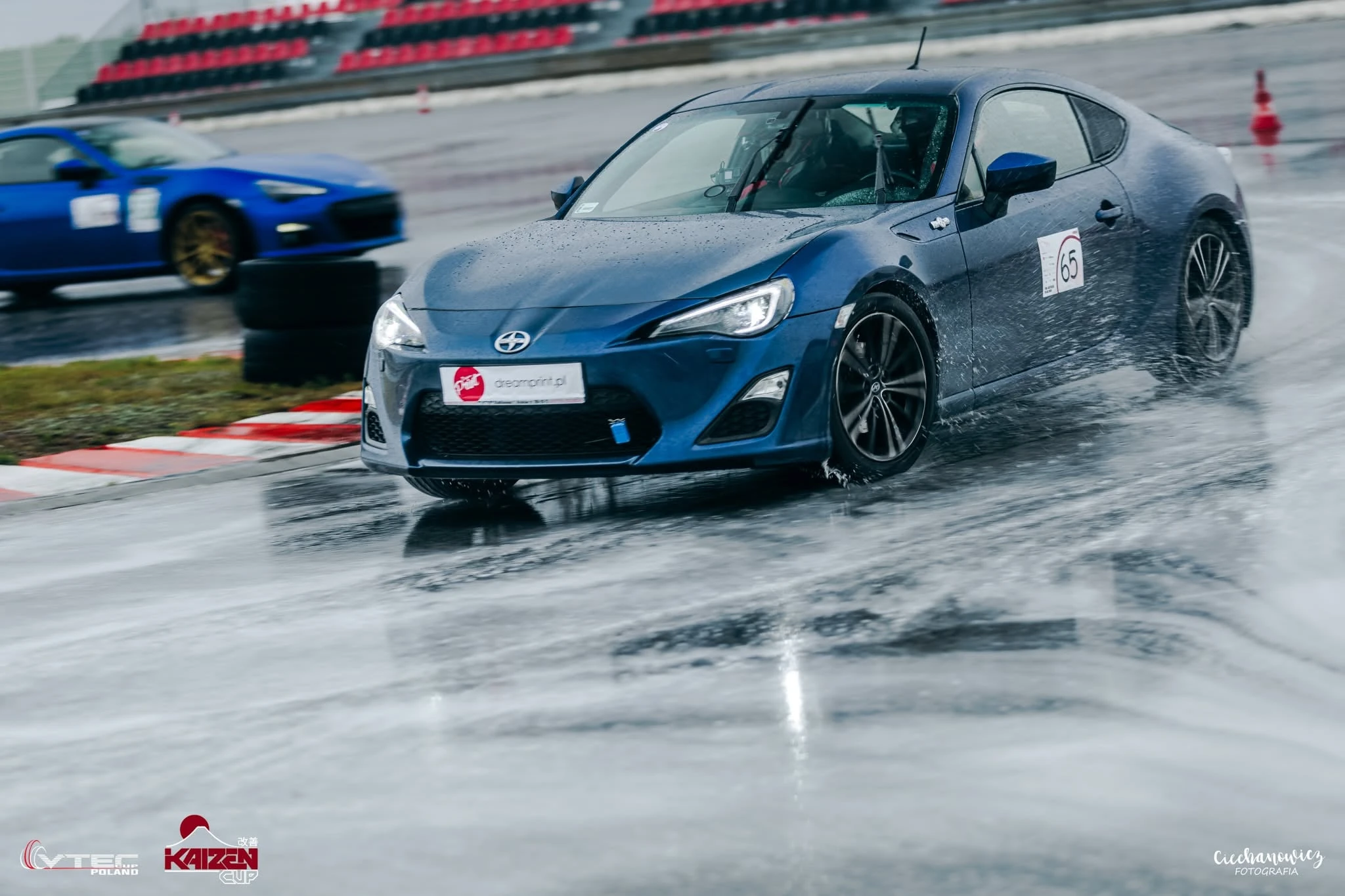 Blue Scion FR-S number 65 driving through standing water at Autodrom Jastrząb